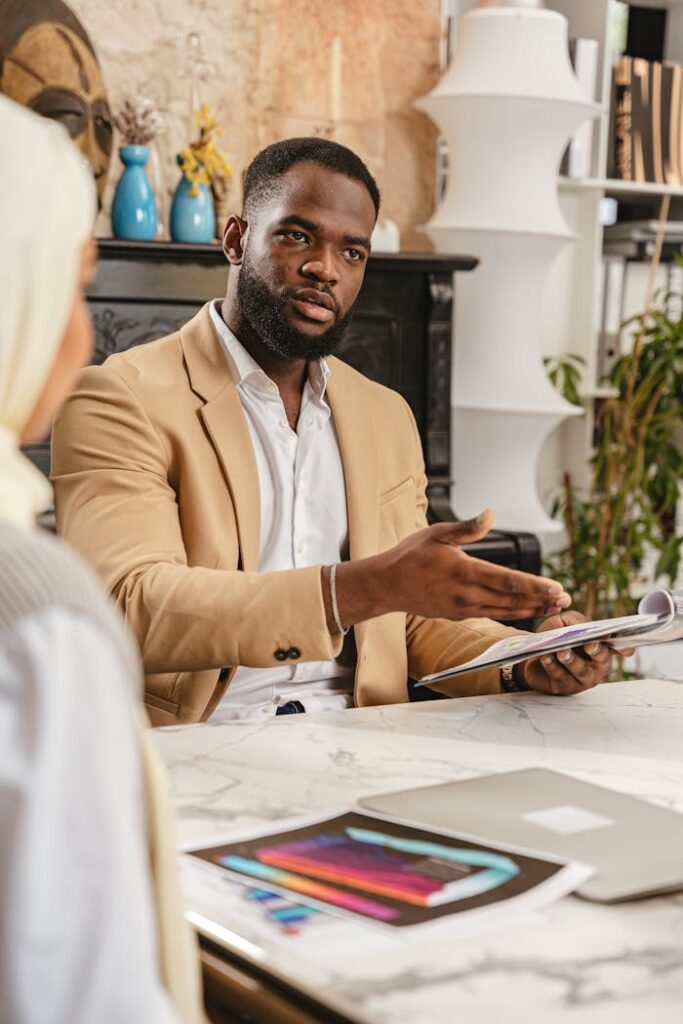 Diverse team in a business meeting discussing documents at a modern office desk.